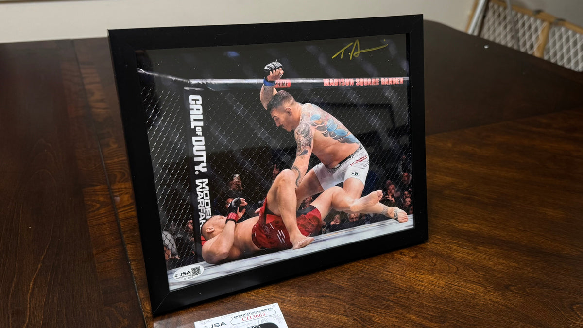Angled view of Tom Aspinall signed UFC 295 action photo with gold autograph and black frame.
