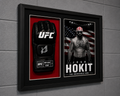 A framed UFC memorabilia display mounted on a gray wall, featuring a black UFC glove on a red background and a black-and-white portrait of Josh Hokit with an American flag backdrop inside a black frame.
