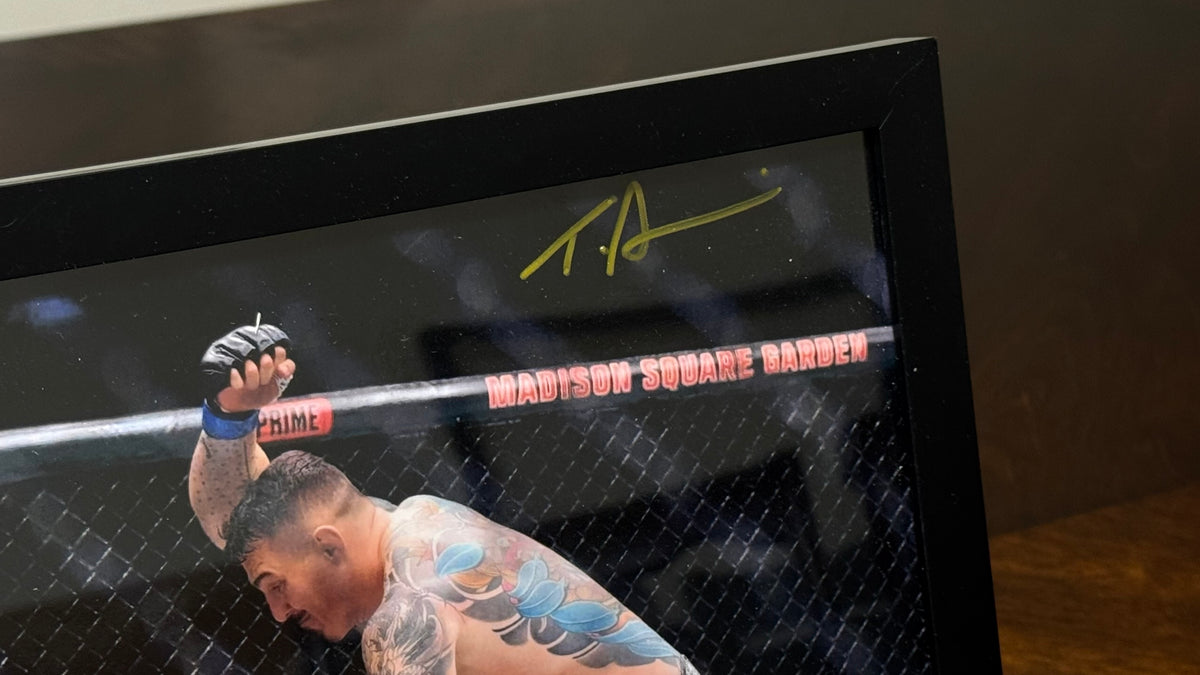 Close-up of Tom Aspinall's metallic gold autograph on the UFC 295 signed 8x10 photo.