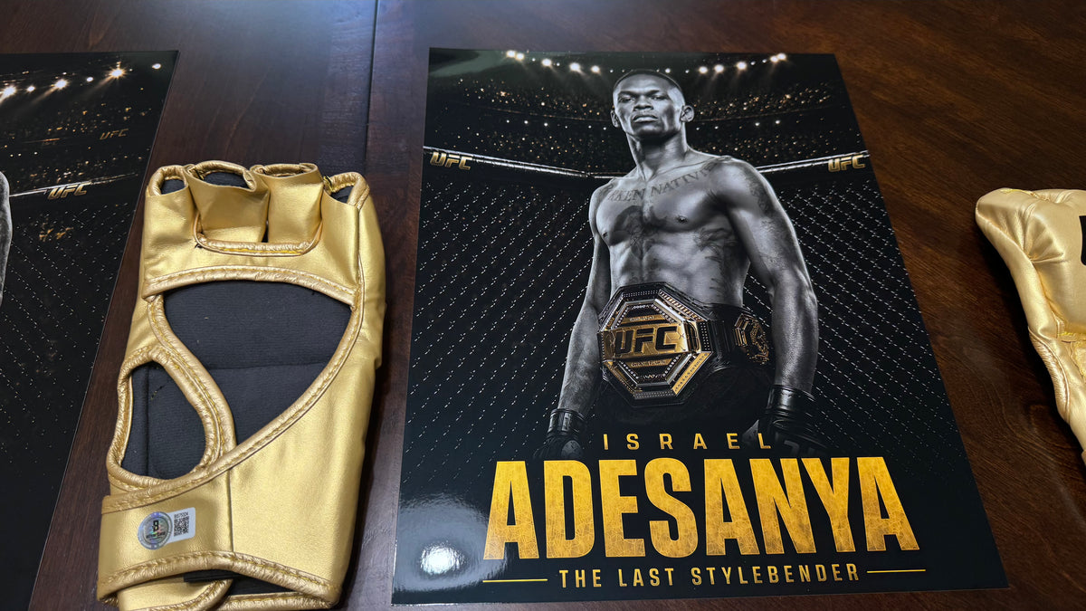 Israel Adesanya hand-signed gold UFC glove authenticated by Beckett Authentication Services under certification BS75324.