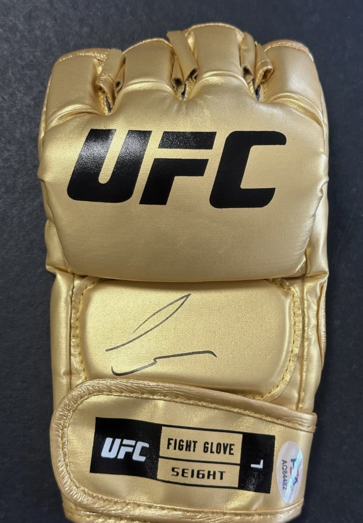 PSA/DNA authentication sticker AA84482 on the Conor McGregor signed gold UFC glove.