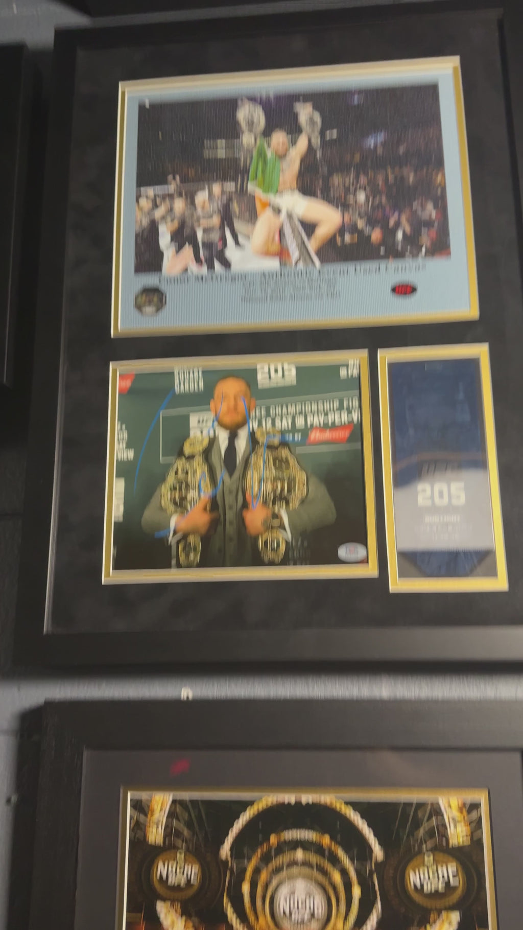 Conor McGregor UFC 205 memorabilia display featuring PSA authenticated autograph and event-used canvas