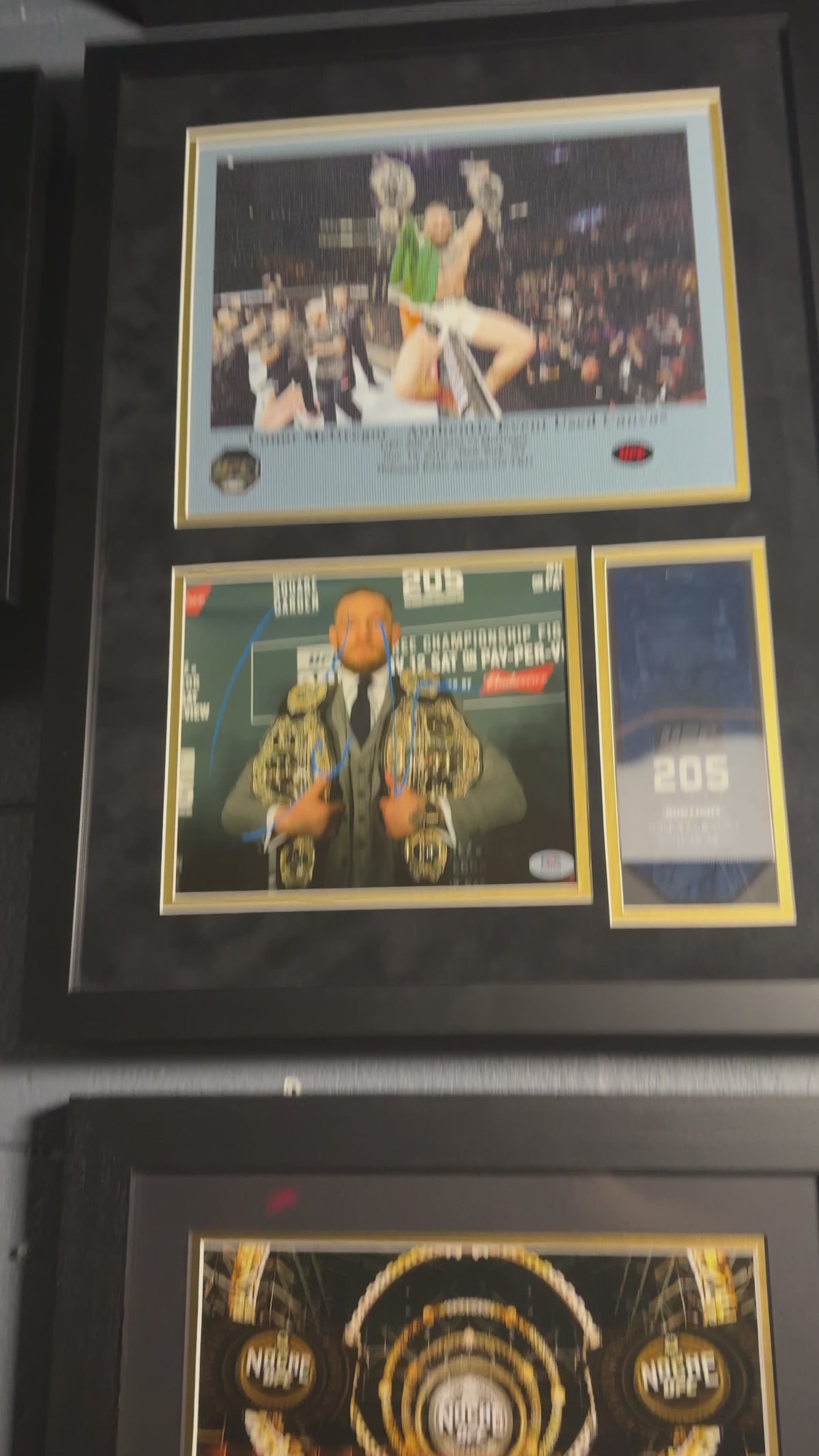 Conor McGregor UFC 205 memorabilia display featuring PSA authenticated autograph and event-used canvas