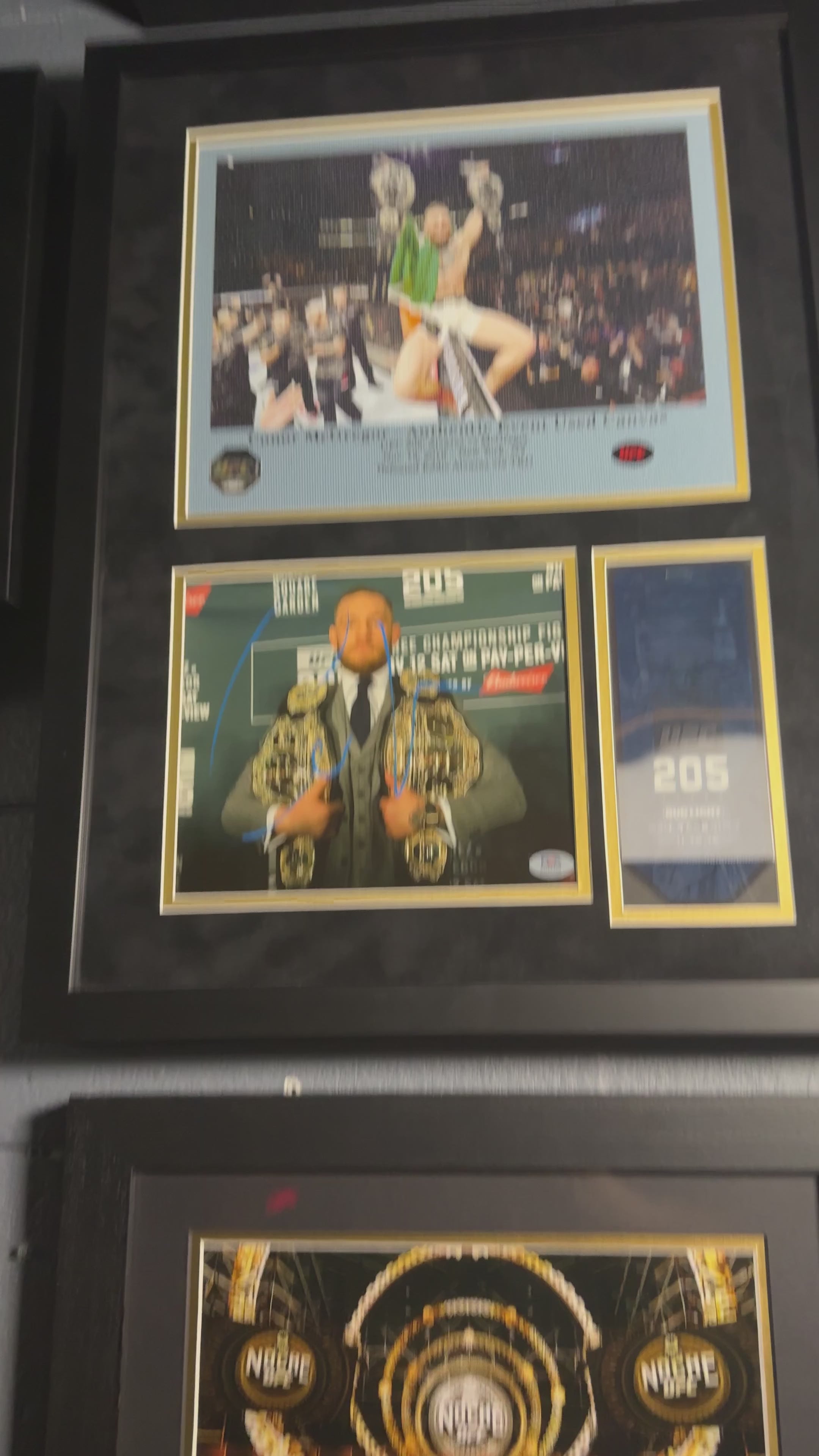 Conor McGregor UFC 205 memorabilia display featuring PSA authenticated autograph and event-used canvas